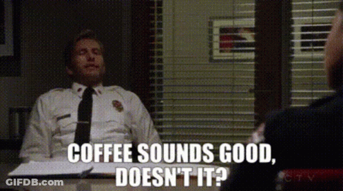 Police Officer Sitting At Desk Saying Coffee Sounds Good Doesn't It GIF