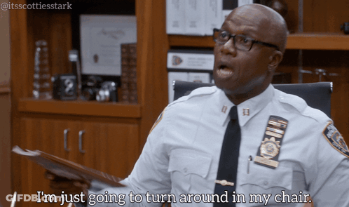 Police Officer Sitting At Desk Says I'm Just Going To Turn Around In My Chair GIF