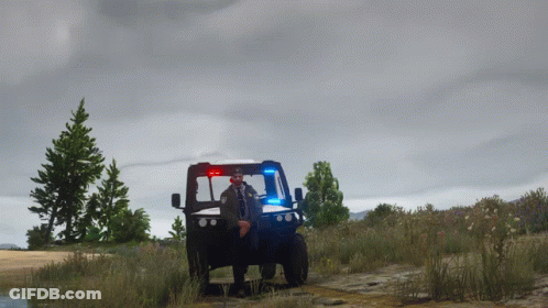 Police Officer Standing In Front Of Blue Utility Vehicle GIF