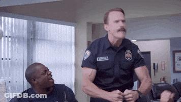 Police Officer With Mustache Standing Next To Another GIF