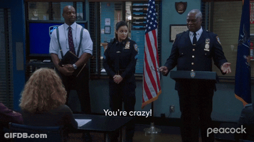 Police Officers In Front Of American Flag Saying How Did You Pull This Off GIF
