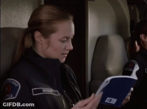 Police Woman On Plane Holding Folder GIF
