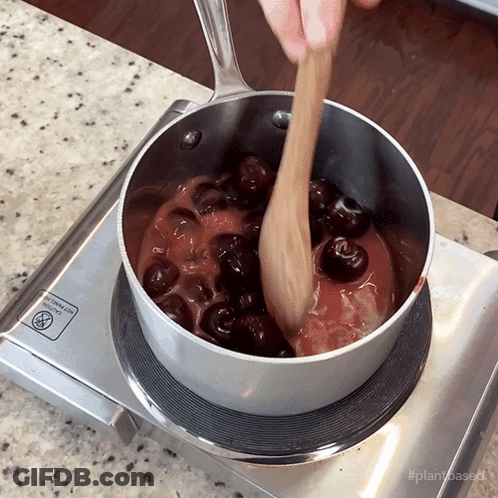 Pot Of Cherry Sauce Stirred On Stove GIF