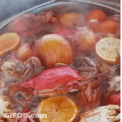 Pot Of Food With Crabs And Lemon Slices GIF