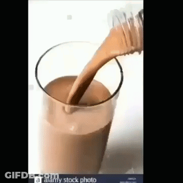 Pouring Chocolate Milk From Bottle Into Glass GIF