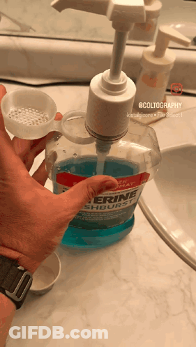Pouring Glycerine Mouthwash Into Measuring Cup GIF