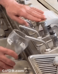 Pouring Water Into Coca Cola Glass GIF