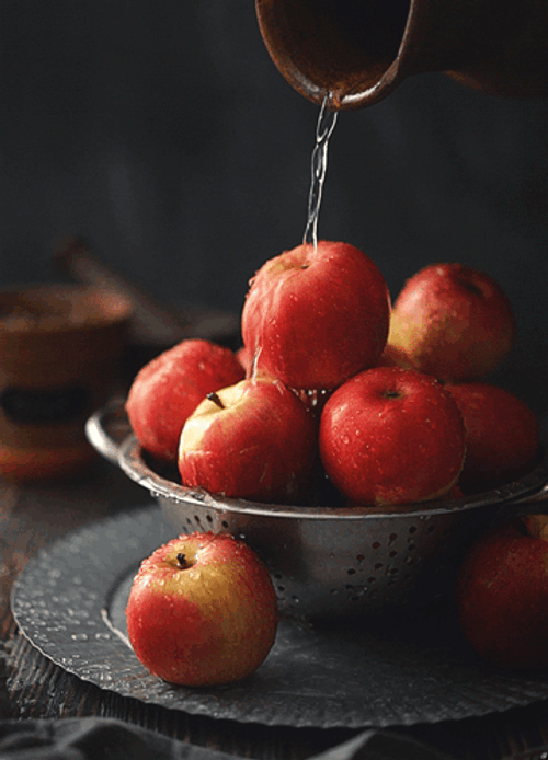 Pouring Water To Apple Fruit Bowl GIF