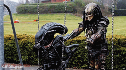 Predator And Alien On Swing Set GIF