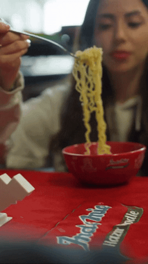 Pretty Woman Blowing Hot Noodles GIF