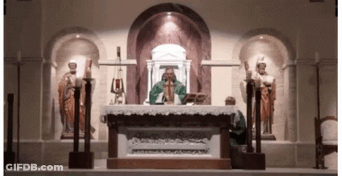 Priest At Church Altar With Statues GIF