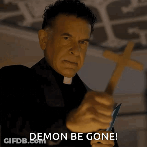 Priest Holding Cross Saying Demon Be Gone GIF