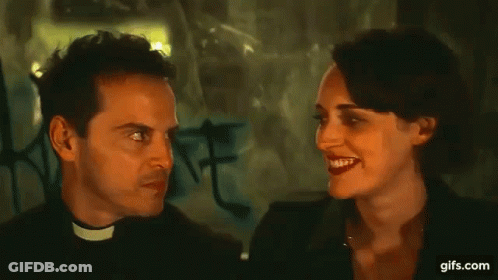 Priest Making Funny Face Talking To Woman In Dark Room GIF