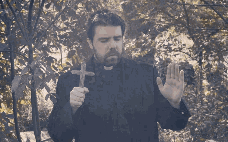 Priest Praying With Cross GIF