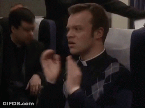 Priest Sitting In Plane With Hands In Air GIF