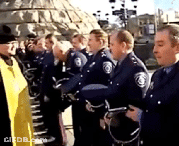 Priest Sprays Holy Water To Officers GIF