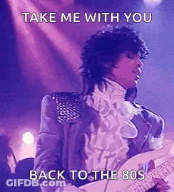 Prince Is Playing A Guitar On Stage And Singing . GIF