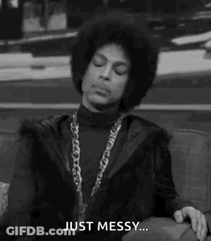 Prince Is Sitting On A Couch In A Black And White Photo And Saying `` Just Messy '' . GIF