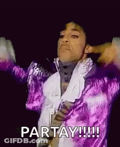 Prince Is Wearing A Purple Jacket And A White Shirt And Is Dancing On Stage . GIF