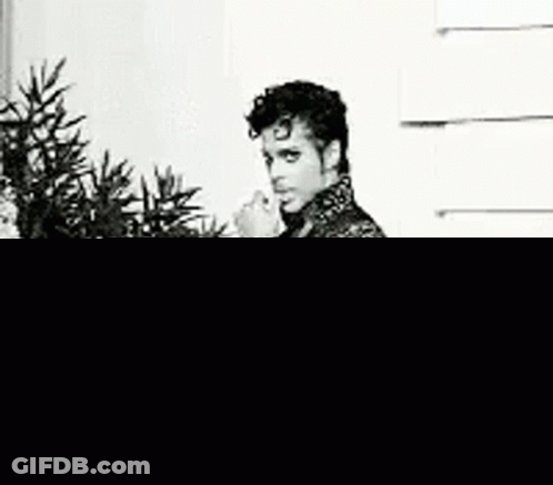Prince Standing Before Christmas Tree GIF
