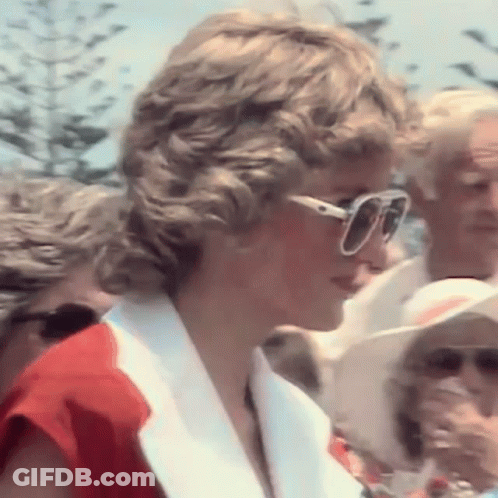 Princess Diana Is Wearing Sunglasses And A Red And White Jacket . GIF