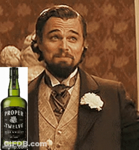 Proper Twelve Whiskey Bottle Next To Man In Suit GIF