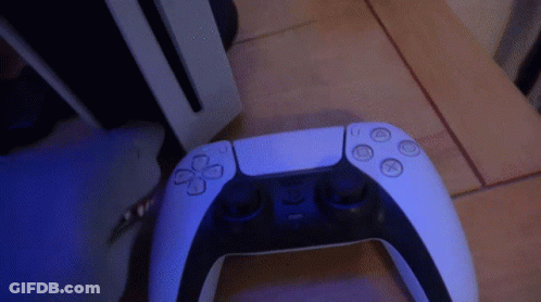 PS5 Controller On Wooden Floor GIF