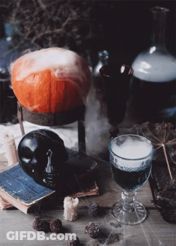 Pumpkin On Stand Next To Glass Of Wine GIF