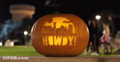 Pumpkin With Howdy Carved On Sidewalk GIF