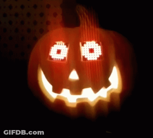 Pumpkin With Pixelated Face Lit In Dark GIF