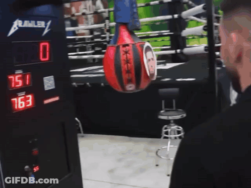 Punching Bag With Man Hanging From Crawler GIF