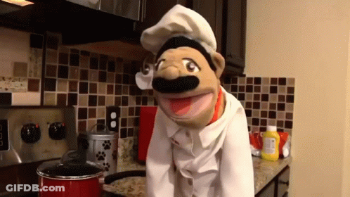 Puppet In Chef Hat Standing In Kitchen GIF