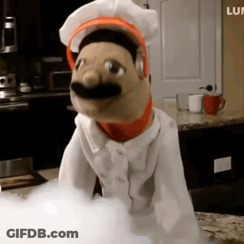 Puppet In Chef Outfit On Counter GIF