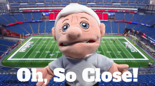 Puppet In Front Of Football Field Saying Oh So Close GIF