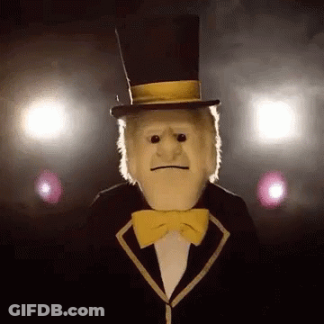 Puppet In Top Hat And Bow Tie Standing In Dark Room GIF