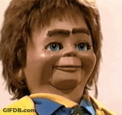 Puppet In Yellow Jacket, Blue Shirt And Tie GIF