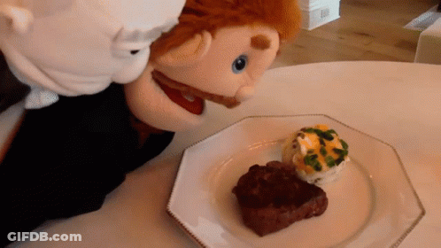 Puppet Looking At Plate Of Steak GIF