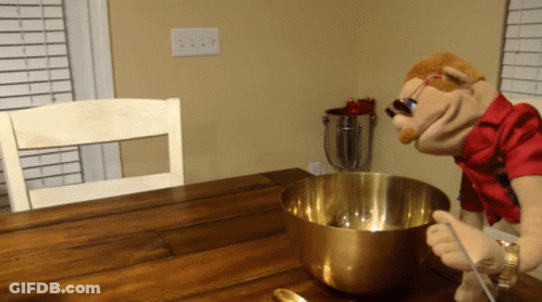 Puppet Mixing In Metal Bowl With Spoon GIF