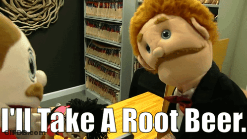 Puppet Says I'll Take A Root Beer Sitting At Table GIF