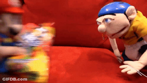 Puppet With Blue Helmet Sitting On Red Couch Next To Another Puppet GIF