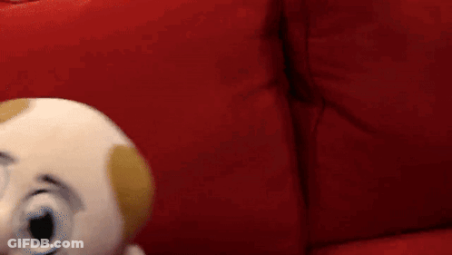 Puppet With Mustache On Red Couch GIF