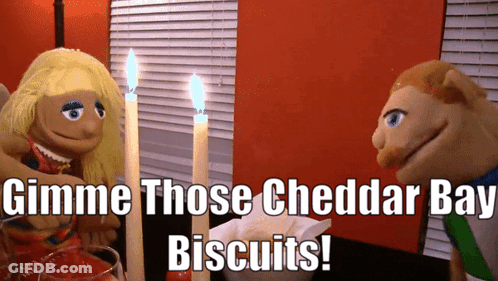 Puppets At Table Say Gimme Cheddar Bay Biscuits GIF