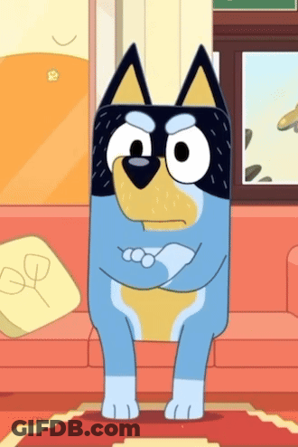 Puppy Sitting On Tiled Floor With Ball In Mouth GIF