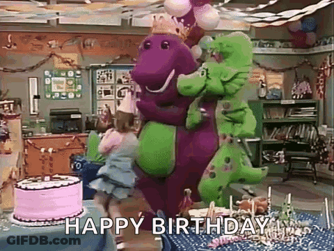 Purple And Green Dinosaur Standing Next To Birthday Cake GIF