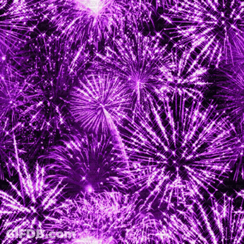 Purple And White Fireworks Are Exploding In The Night Sky . GIF