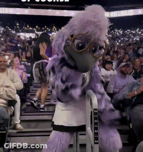 Purple Bird Mascot In Front Of Crowd With Letters A And A GIF