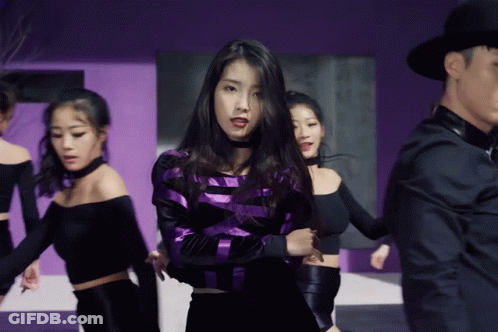 Purple Black Striped Woman Surrounded By Women GIF