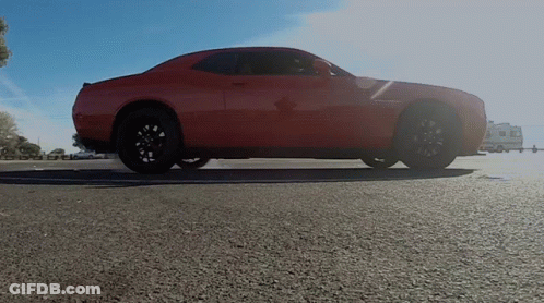 Purple Car Driving Past Speed Limit Sign In Parking Garage GIF