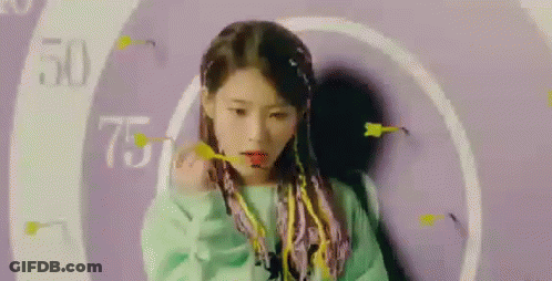 Purple-Haired Girl Holding Dart By Purple Wall GIF