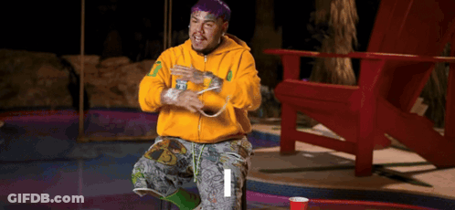 Purple-Haired Man In Yellow Hoodie Sitting GIF